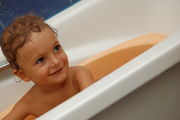 happy little boy taking a bath