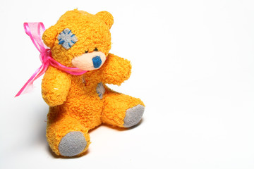 Patched teddy bear on white background