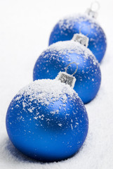 Blue christmas balls lying on the snow. aRGB.