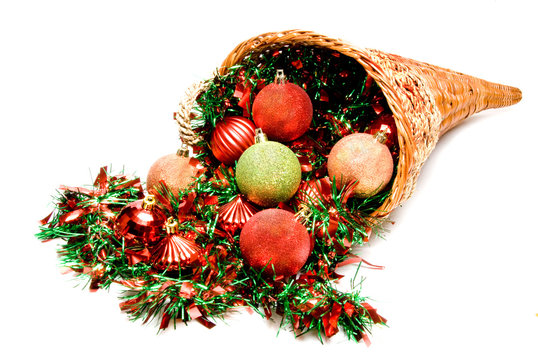 A cornucopia filled with holiday Christmas ornaments.