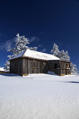 Fototapeta premium Mountain house in snow, winter sunny day