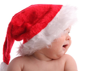Child in a Christmas hat looking aside 3