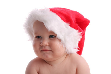 Child in a Christmas cap looking aside