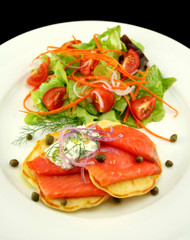 Corn fritters with smoked trout with capers and cottage cheese.