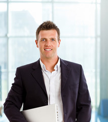 Fototapeta premium Happy businessman smiling at office lobby.