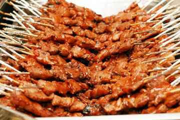 lots of pork barbecue in a stick.