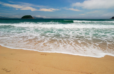 Surf at solar coast of Pacific ocean.