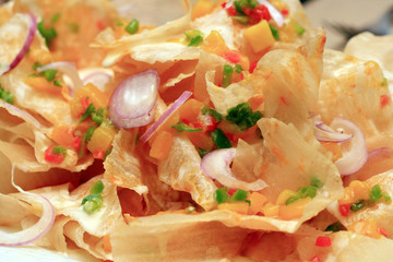 oriental flavored nachos served in a dish.