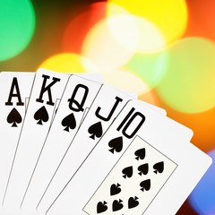 Spades royal flush close-up over colorful background