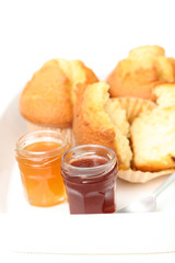 Fototapeta na wymiar fresh muffins and jars of delicious jam - sweet dessert