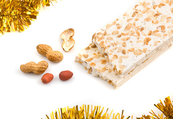 Nougat and peanuts on white background, close up shot.