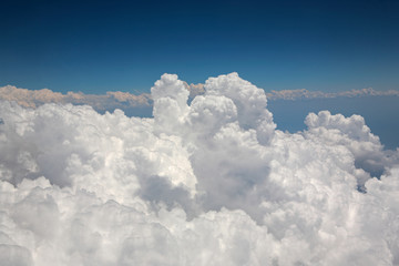 Naklejka na ściany i meble Large White Cumulus Clouds seen from Window of Airplane