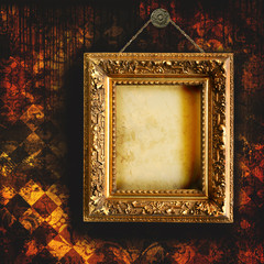 Grungy tattered wallpaper with empty picture frame