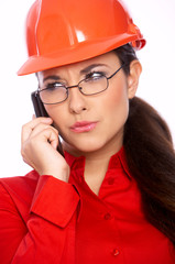 Female architect talking cell phone, isolated on white