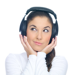 Beautiful young lady is liten to the music, isolated