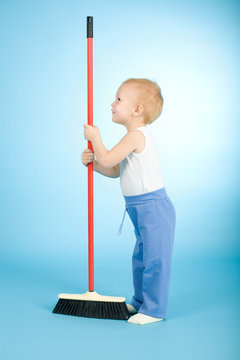 Joyful boy with cleaning swab over blue