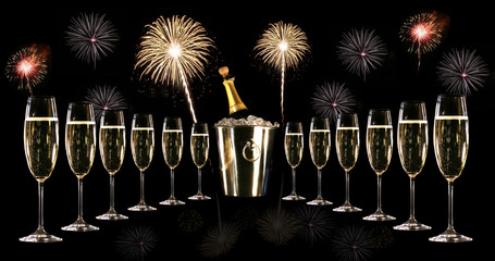 Glasses of champagne with silver ice bucket and fireworks