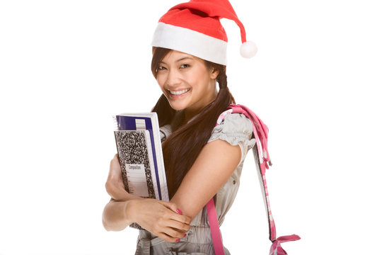 Asian student girl in Christmas Santa hat with composition book