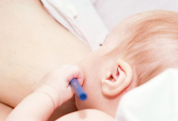 Obraz na płótnie Canvas newborn baby breastfeeding
