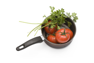 tomatoes and parsley in stew-pan