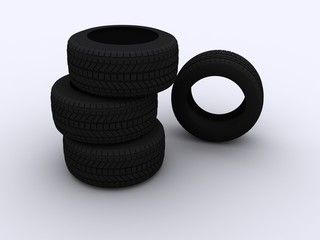 a stack of four car tyres