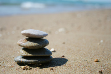 Fototapeta na wymiar Stones stacked up on beach
