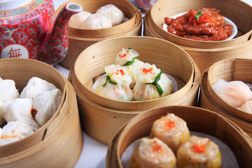 variety of dim sum in bamboo steam containers - obrazy, fototapety, plakaty