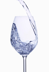A stream of water being poured into a glass