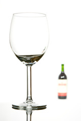 Empty glass and wine bottle