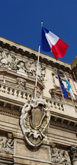 Fototapeta na wymiar Drapeau Tricolore, fasady de pierre, Ciel Bleu, Francja.