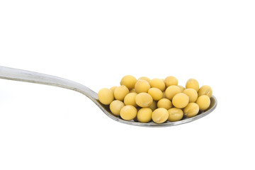Spoonful of soy beans isolated on white background
