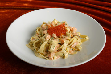 Paste with slices of a salmon and red caviar.