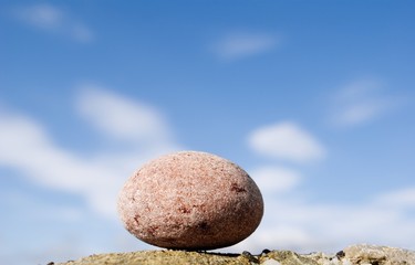 round stone on a background sky