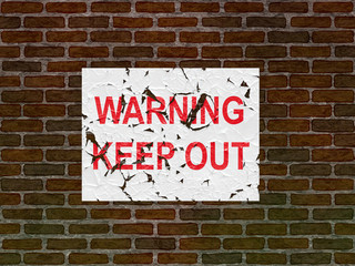 Fototapeta na wymiar Faded and worn warning poster on an old brick wall