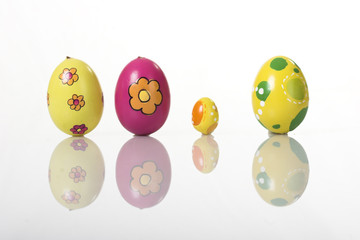 Colored Easter eggs isolated on white with reflection