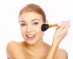 Portrait of beautiful blond woman doing makeup, on white