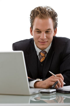 Businessman working on laptop isolated