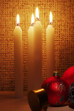 The burning candles, balls and ribbons it are Christmas