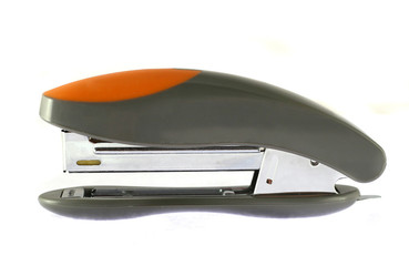 gray-orange isolated stepler over black background