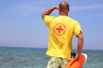 male lifeguard holding a life buoy