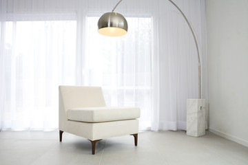 Contemporary interior with lamp and chair - obrazy, fototapety, plakaty