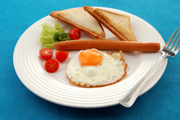 Breakfast - toasts, egg, sausage and vegetables