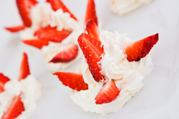 Slices of a strawberry with whipped cream