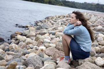 Young woman sitting at the beach