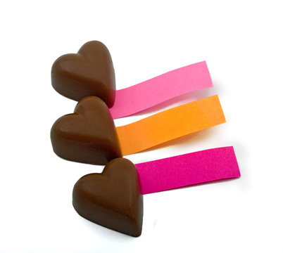 three chocolate hearts and notes