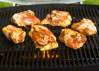 chicken breasts cook on the bar-b-que grill