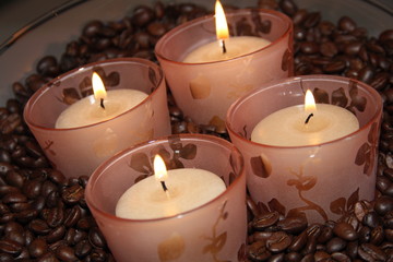 burning candles with coffee beans
