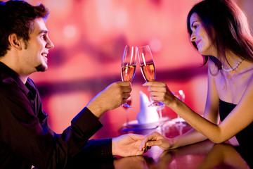 Young couple celebrating with champagne together