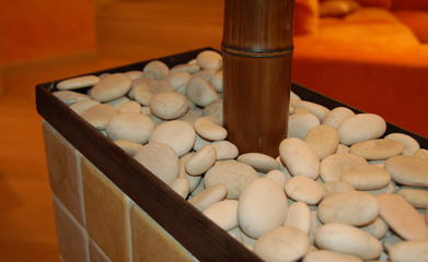 wooden column in basement filled with white stones
