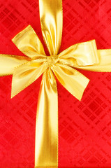Close up of red gift box with gold bow